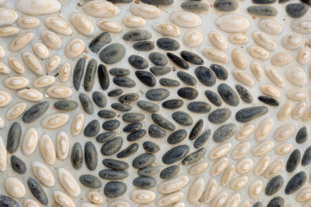 mosaic of a vine leaf with white and black pebbles