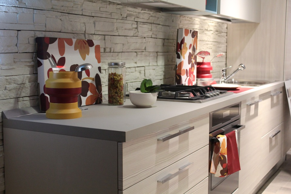 kitchen counter sink and stove with brick splashback