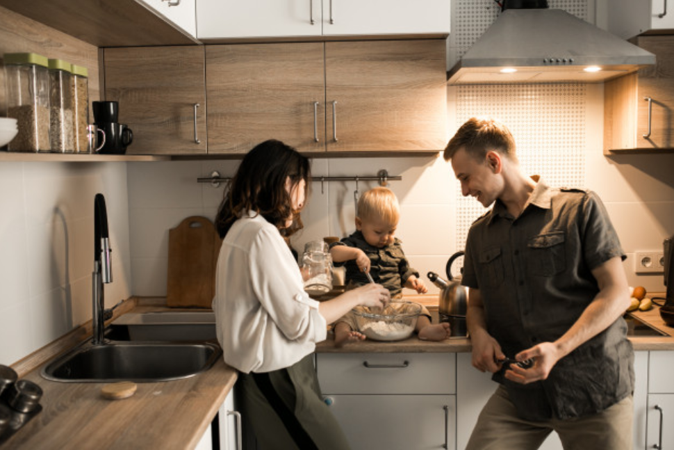 baby with dad and mom in white and wood kitchen