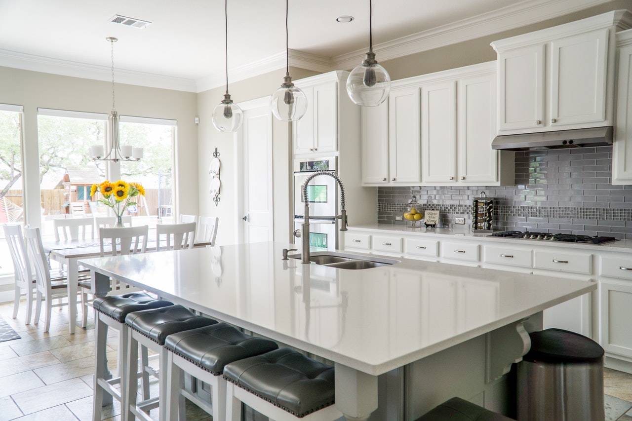 white kitchen island with pendant lights cabinet stools
