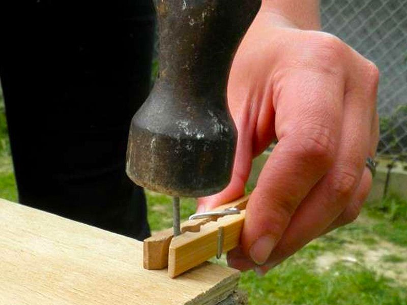 hammer with clothespin holding nail in place